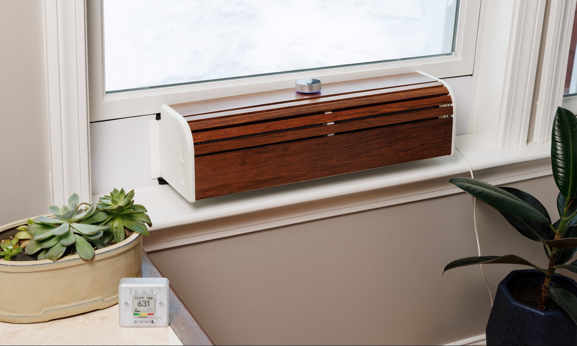 SWERV Window Mounted ERV Installed into beautiful white window organic with plants and an Aranet 4 air quality sensor to improve CO2 levels inside without wasting heat